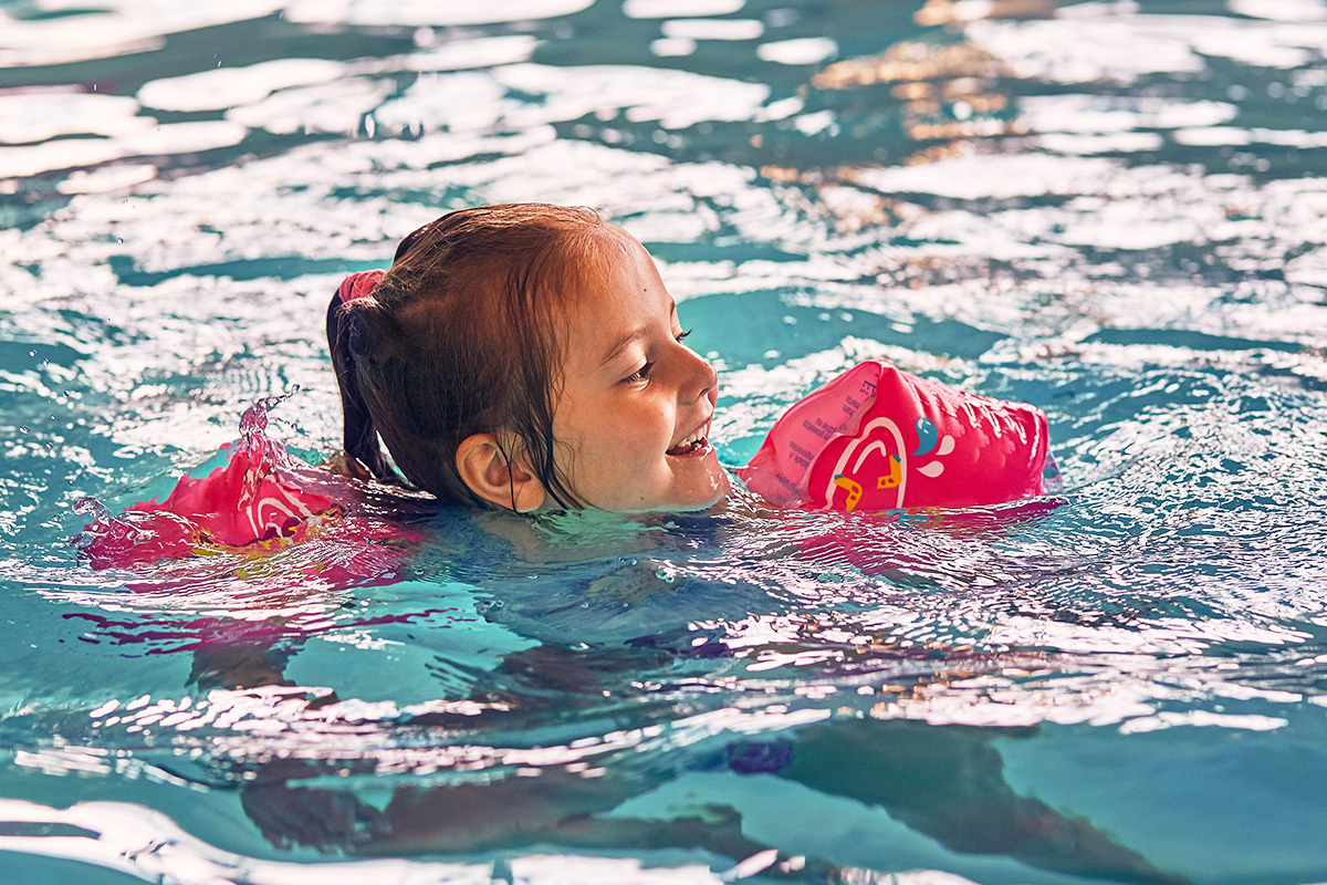 little happy smiling girl playing in water
